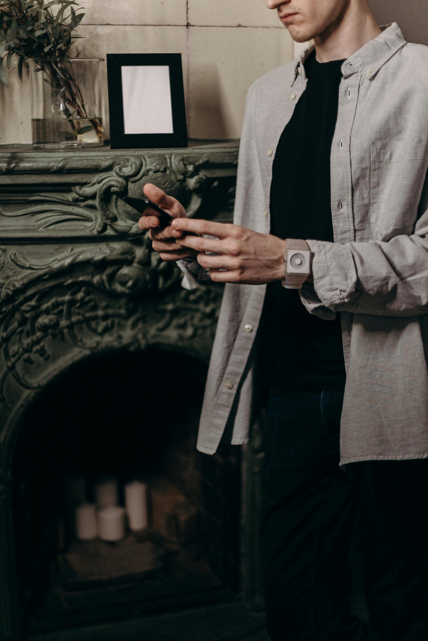 pexels-photo-4068303-4068303 Man using smartphone in a cozy home office setup with stylish interior and decor.